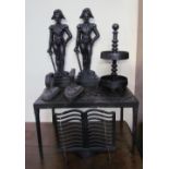 A pair of cast iron door stops in the form of soldiers together with a cast iron footman,