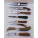 A Winchester folding pocket knife together with seven other folding pocket knives