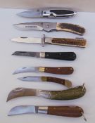 A Winchester folding pocket knife together with seven other folding pocket knives