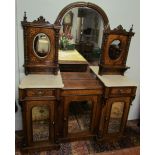 A Victorian walnut chiffonier with a mirrored back,