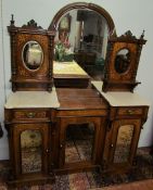 A Victorian walnut chiffonier with a mirrored back,