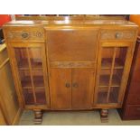 A 20th century oak bureau display cabinet on turned legs