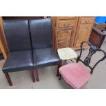 A pair of leather upholstered chairs together with a bedroom chair and an Edwardian nursing chair