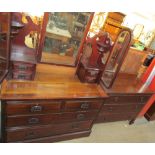 An Edwardian walnut dressing table with three mirrors, the base with two short and two long drawers,