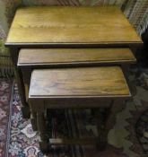 A twentieth century oak nest of three tables