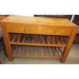 A 20th century oak side table with a pair of drawers on square legs united by slatted racks
