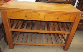 A 20th century oak side table with a pair of drawers on square legs united by slatted racks