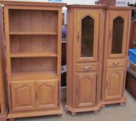 A pair of light oak corner cupboards together with a television cabinet,