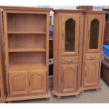 A pair of light oak corner cupboards together with a television cabinet,