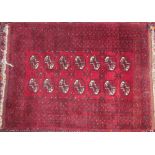 A small Turkoman rug, with a red ground and multiple central medallions and guard stripes,