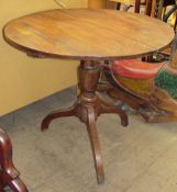 An Elm topped tripod table with a circular planked top and baluster turned column on a tripod base