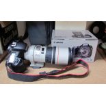 A Canon EOS 7D camera and canon EF 300mm 1:4 LIS lens CONDITION REPORT: Not sold as