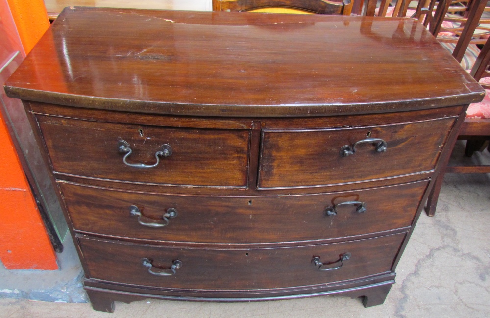 A 19th century mahogany chest with a bowed top above two short and two long drawers on bracket