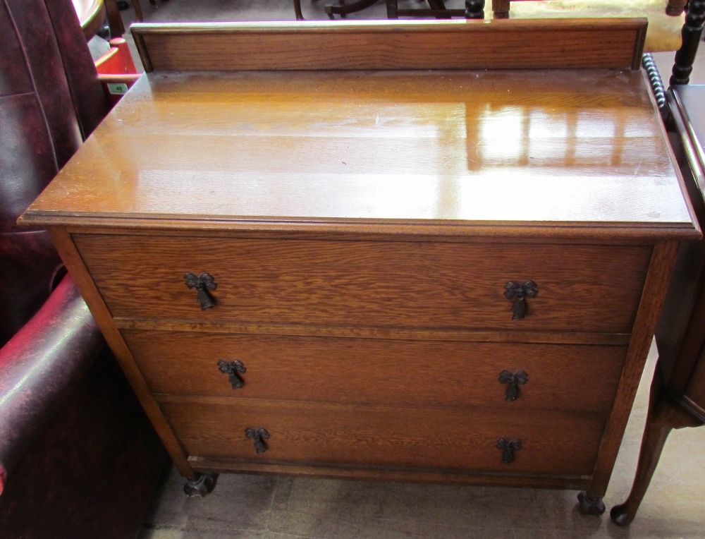 A 20th century oak dressing chest with three drawers together with a matching dressing table