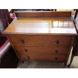 A 20th century oak dressing chest with three drawers together with a matching dressing table