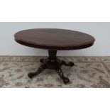 A Victorian rosewood supper table the oval top with a shallow apron,