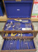 An electroplated part flatware service contained within an oak cabinet