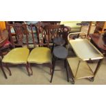 A pair of upholstered salon chairs together with a pair of stools and a tea trolley