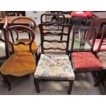 A pair of Victorian walnut framed balloon back dining chairs with stuffer seats on shaped legs