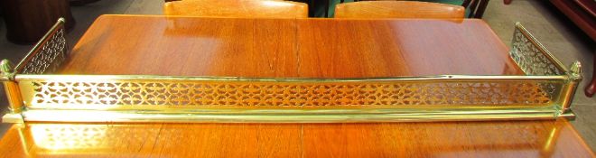 A Pierced brass fire fender with reeded finials ***TO BE RE-OFFERED IN A FUTURE SALE FOR ESTIMATES