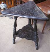 A carved oak wine table with a brass triangular table top on ring turned baluster legs,