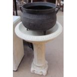 A reconstituted stone bird bath together with a cauldron planter