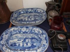Four blue and white meat plates together with a bakelite telephone,
