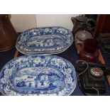 Four blue and white meat plates together with a bakelite telephone,