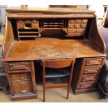 An oak tambour fronted roll top desk,