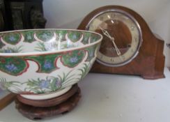 A walnut mantle clock together with an oriental bowl on a stand