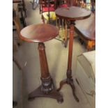 A 19th century mahogany torchere with a moulded circular top on a lotus leaf capped column and