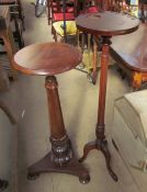 A 19th century mahogany torchere with a moulded circular top on a lotus leaf capped column and