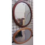 Two oval wall mirrors