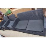 A four piece garden furniture set comprising a settee,