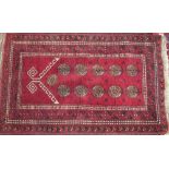 A Turkoman prayer rug with a red ground,