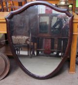 A Shield shaped wall mirror together with three other mirrors