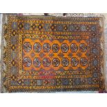 A Turkoman rug with fourteen central medallions to an orange ground,