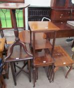 A walnut nest of three tables together with another walnut table,