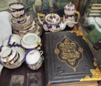 A leather bound bible together with a floral decorated part tea service