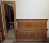 A full length oak framed wall mirror together with an oak bed