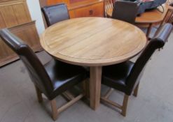 A Modern extending dining table and four chairs