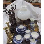 A pair of spelter figures together with a pair of brass candlesticks, oil lamp,