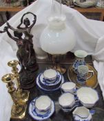 A pair of spelter figures together with a pair of brass candlesticks, oil lamp,