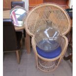 A large glass bottle together with a wicker chair and a mirror