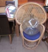 A large glass bottle together with a wicker chair and a mirror