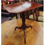 A 19th century mahogany tripod table with a rectangular top with cut corners on a ring turned