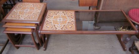 A G-Plan teak tiled and glass coffee table together with a teak and tiled top nest of tables