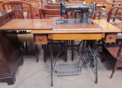 ****WITHDRAWN**** An oak cased Singer sewing machine table with treadle base