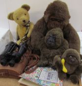 A teddy bear together with stuffed gorillas,