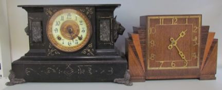 A black painted mantle clock together with an oak mantle clock